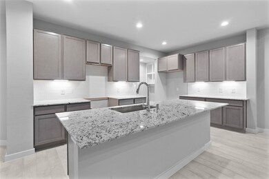 The open concept living room and kitchen makes for a great way to keep the party going and never miss a beat! Gather the family together in good conversation while preparing a fabulous meal in this breathtaking kitchen! Featuring high ceilings, light stained wood cabinets, granite countertops, SS appliances, modern tile backsplash, recessed lighting, and kitchen island with ample counter space!