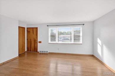 Unfurnished room featuring light wood-style flooring