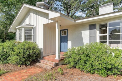 Property entrance featuring board and batten sidin