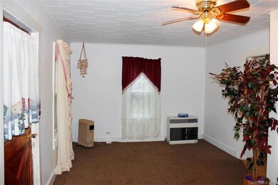 Freshly painted living room with ceiling fan.