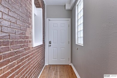 View from end of entryway hall towards front door