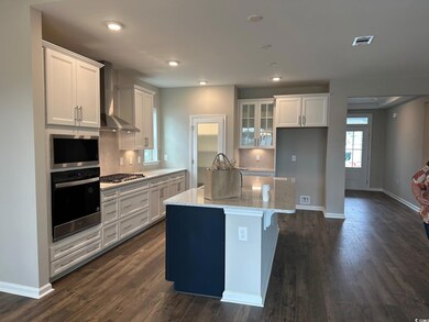 Kitchen with a center island, light stone counters