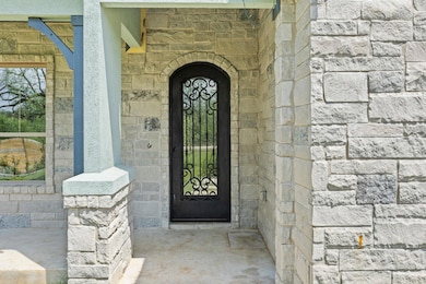 Doorway to property with stone siding