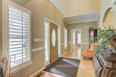 Large 2 story Foyer entry with chair railing and leaded glass front door.