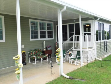 Carport area offers additional sitting area.