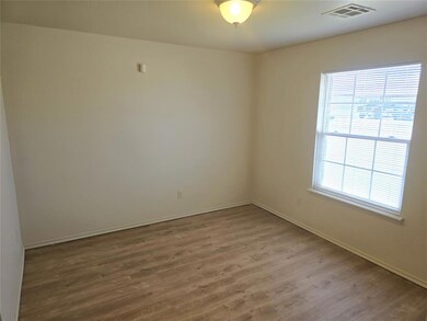 Spare room featuring baseboards, visible vents, an