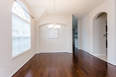 The dining room is simply stunning with arched windows and even an arched recessed wall.