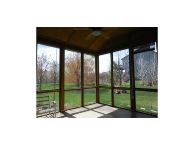 Huge screened in porch with ceiling fan.