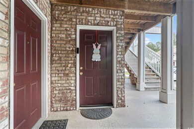 Property entrance featuring brick siding