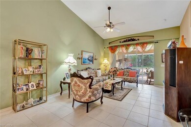 Living area with ceiling fan, light tile patterned