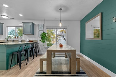 Dining room featuring a textured ceiling, light wood-style floors, and recessed lighting