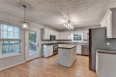 Kitchen featuring light wood-style flooring, appli