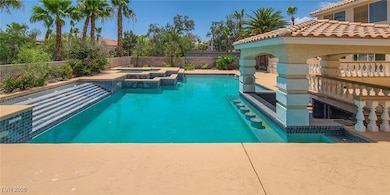 View of pool featuring a patio, a fenced backyard, and a pool with connected hot tub