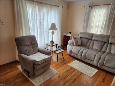Hardwood floored living room with a healthy amount