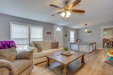 Living area with lofted ceiling, a textured ceilin