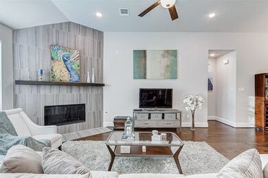 Contemporary fireplace with clean lines and grey tones it is the perfect focal point in the family area. Cozy up on those cooler winter evenings!