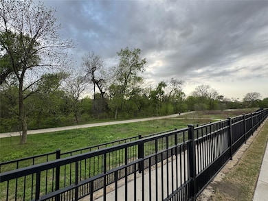 View of home's community with fence and a yard