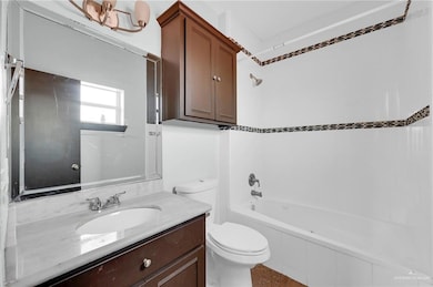 Spare room with a tray ceiling, baseboards, and ceiling fan