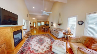 Living area with ceiling fan, visible vents, a fir
