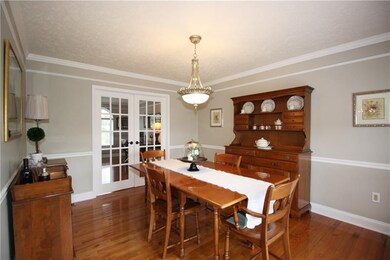 Formal Dining Room with Crown Molding and Chair ra