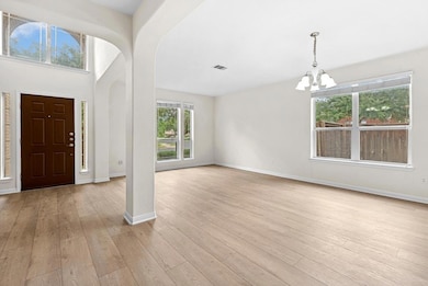 Foyer featuring a chandelier, light wood-type flo