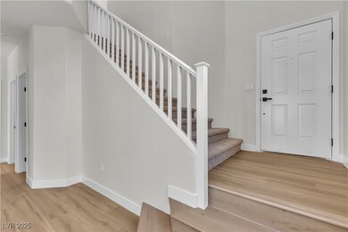 Foyer featuring wood finished floors, baseboards,