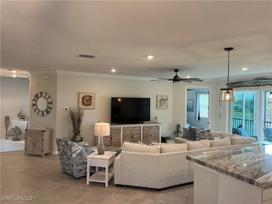 Tiled living room featuring ceiling fan and orname