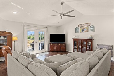 Bright and cheery living area with view to patio.