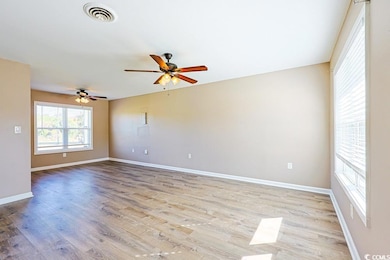Spare room with light wood-style floors and ceiling fan