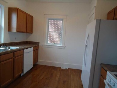 Kitchen. The equipped kitchen has new hardwood flo