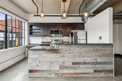 Kitchen featuring concrete floors, tasteful backsp
