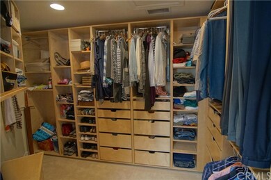 Walk in closet in master bedroom with built-ins