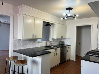 Kitchen featuring backsplash, dark wood-type floor