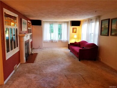 Large bright living room with hardwoods under carp