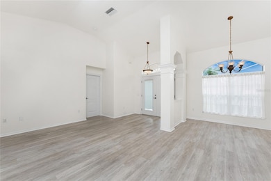 Living room looking at front entry and dining room