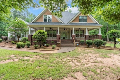 Craftsman inspired home featuring ceiling fan, a shingled roof, a porch, and a front lawn
