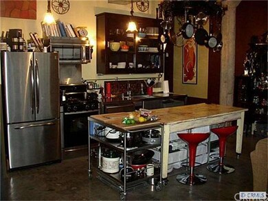 Kitchen are with stainless steel counters, sink an