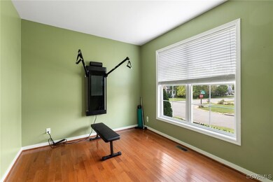 Exercise room featuring light hardwood / wood-styl
