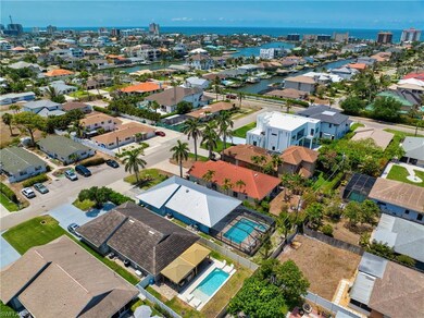 Aerial view of residential area featuring a nearby body of water