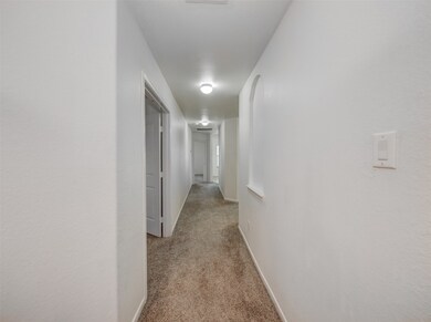 From the front door this hall way leads to the study on the left, primary bedroom in the back and living areas.