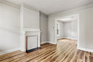 Unfurnished living room with light wood-style floo