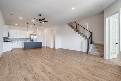  living room with stairway, light wood finished floors, recessed lighting, and ceiling fan