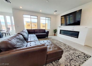 Living area featuring visible vents, baseboards, a