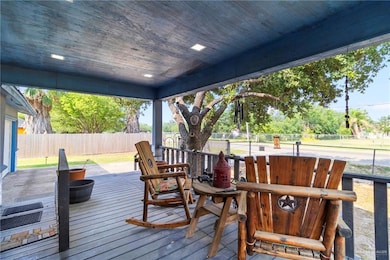 Wooden deck with a fenced backyard