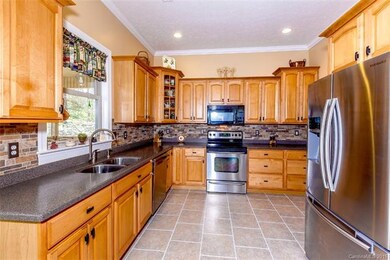 Maple cabinetry, SS appliances, solid surface coun