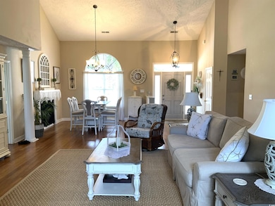 A view from the Carolina room into the large living space and dining area.