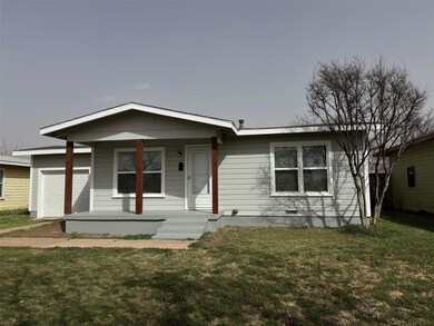 View of front of property with a garage and a fron