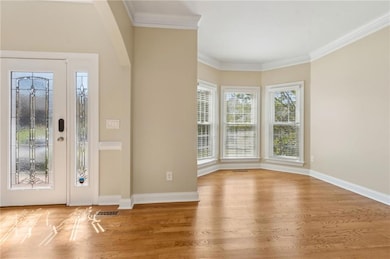 Foyer with visible vents, ornamental molding, base