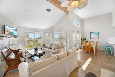 The interior has an open floorplan with vaulted ce