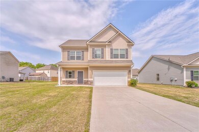 View of front of property with a front yard, an at